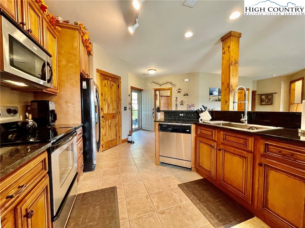 114 Red Deer Road, Unit D Banner Elk, NC 28604 - Photo 7 of 40 a large kitchen with stainless steel appliances and cabinets