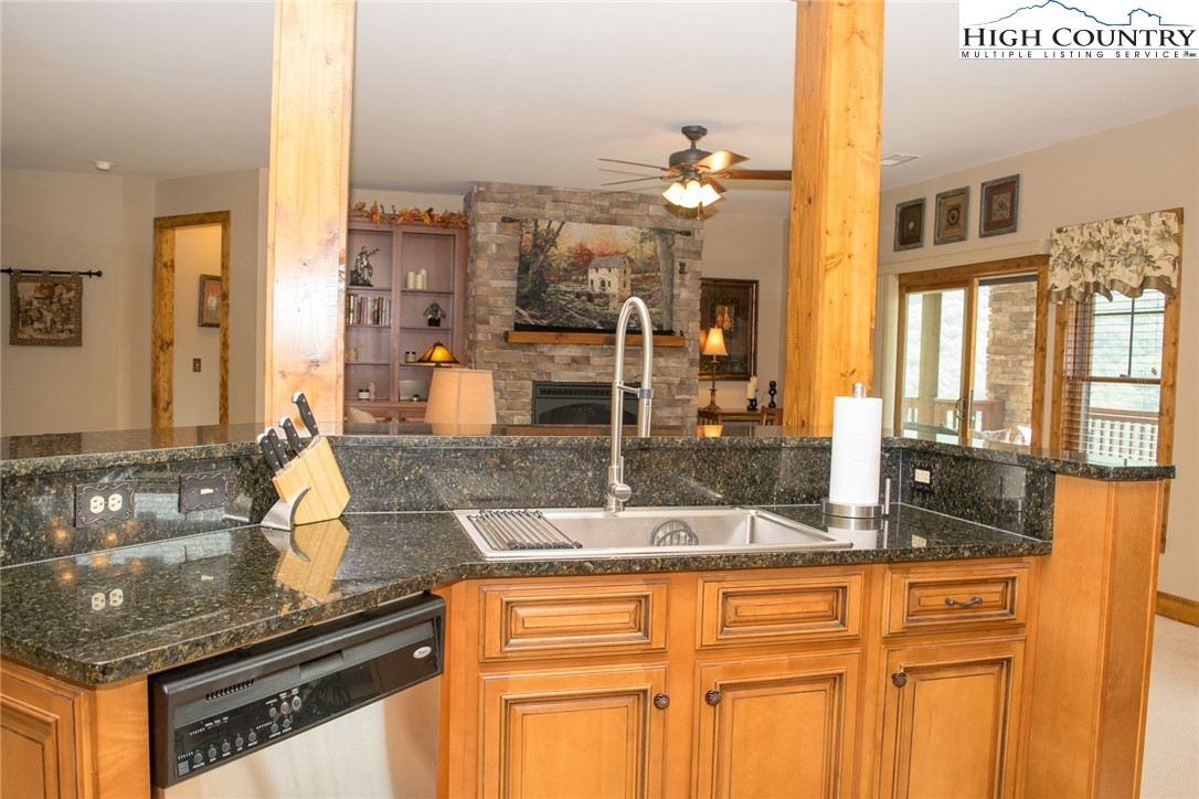 114 Red Deer Road, Unit D Banner Elk, NC 28604 - Photo 8 of 40 a kitchen with stainless steel appliances granite countertop a sink and cabinets