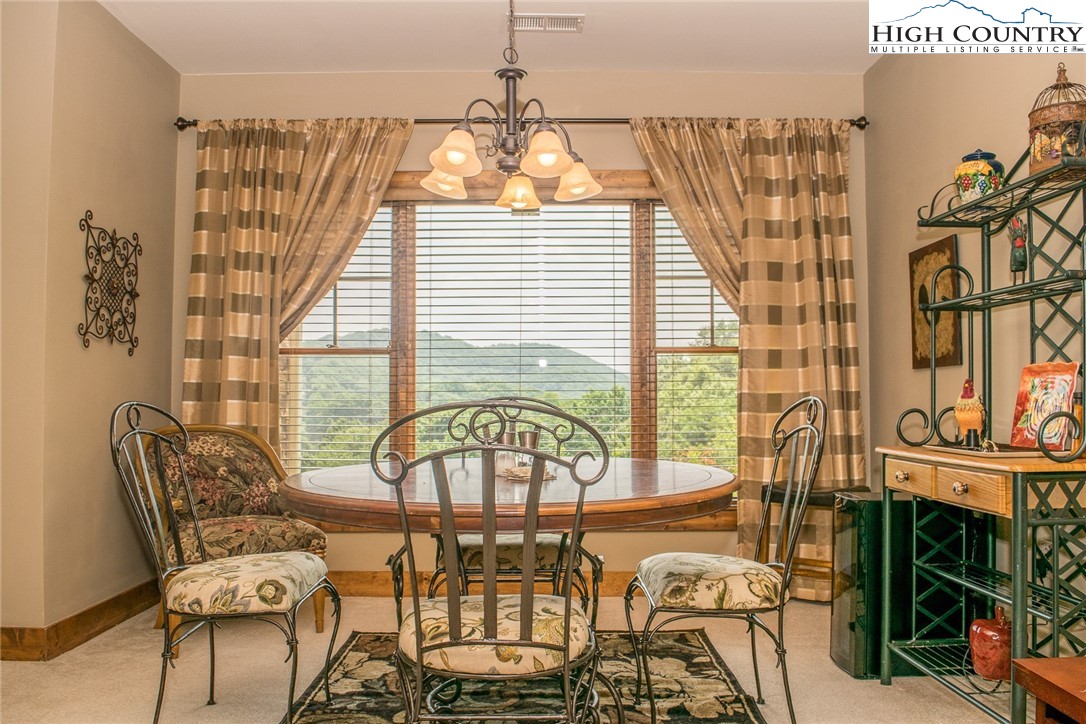 114 Red Deer Road, Unit D Banner Elk, NC 28604 - Photo 10 of 40 a view of a dining room with furniture window and outside view
