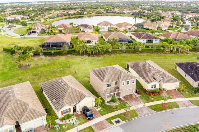 an aerial view of residential houses with outdoor space and river