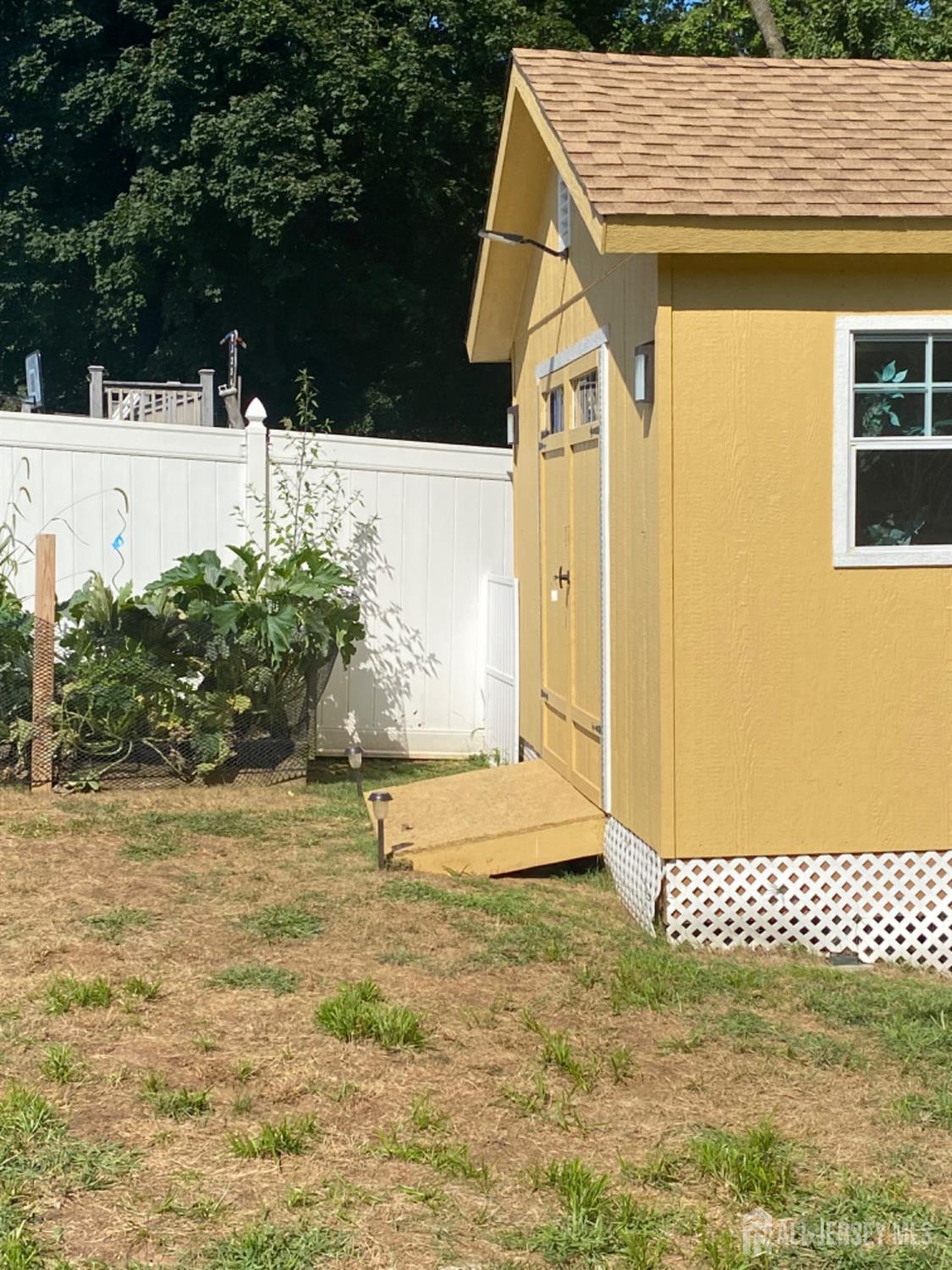 27 Brookside Road Edison, NJ 08817 - Photo 18 of 30 a view of a wooden house with a yard