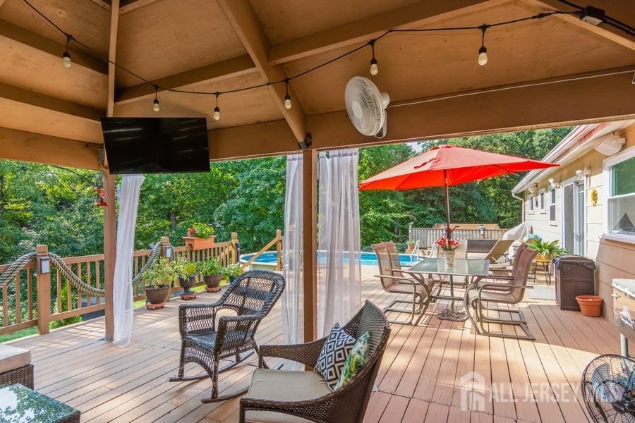 27 Brookside Road Edison, NJ 08817 - Photo 21 of 30 a patio with a patio table and chairs