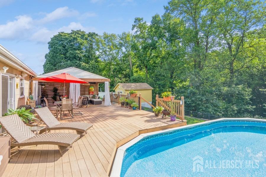 27 Brookside Road Edison, NJ 08817 - Photo 24 of 30 a view of backyard with swimming pool and seating space
