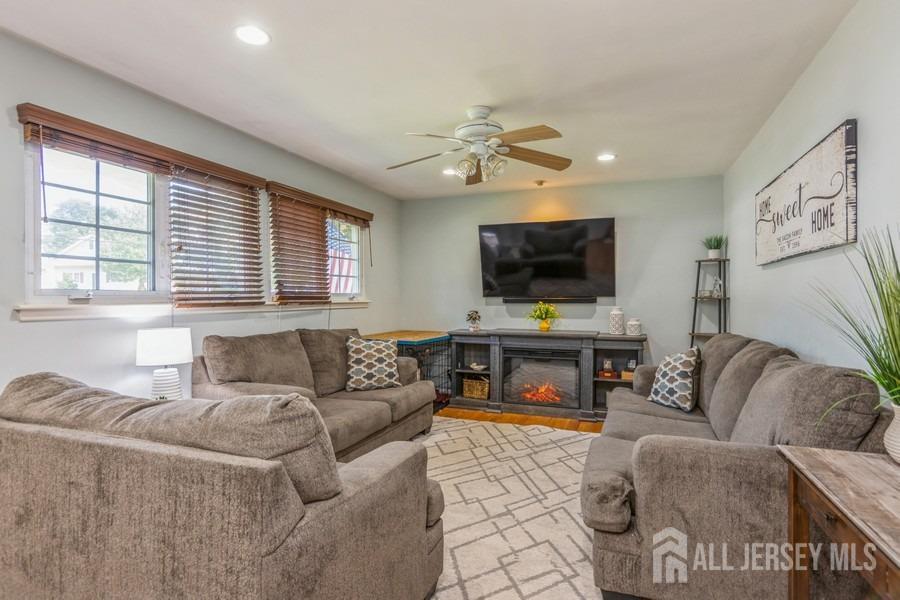 27 Brookside Road Edison, NJ 08817 - Photo 3 of 30 a living room with furniture and a flat screen tv