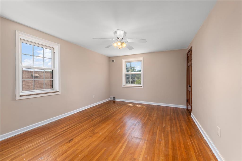 908 Greenhill Road Pittsburgh, PA 15209 - Photo 13 of 23 wooden floor in an empty room with a window