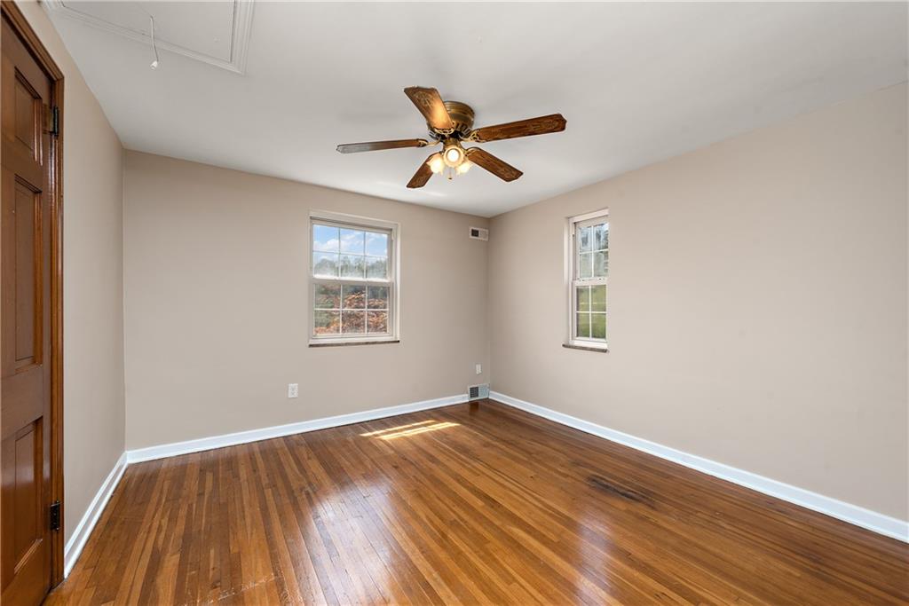 908 Greenhill Road Pittsburgh, PA 15209 - Photo 14 of 23 a view of a room with wooden floor and ceiling fan