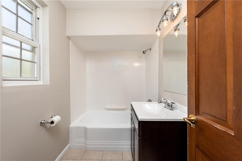 908 Greenhill Road Pittsburgh, PA 15209 - Photo 16 of 23 a bathroom with a sink mirror and a bathtub