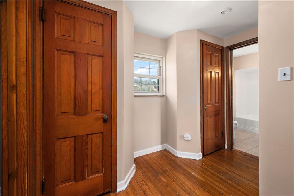 908 Greenhill Road Pittsburgh, PA 15209 - Photo 17 of 23 an empty room with wooden floor and a window