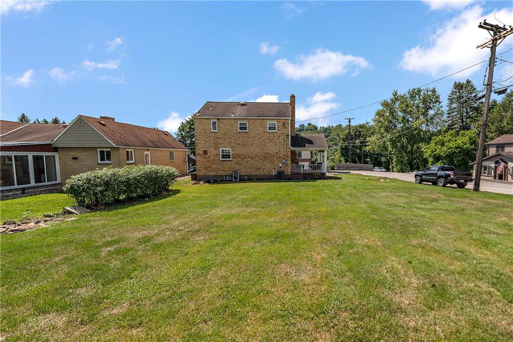 908 Greenhill Road Pittsburgh, PA 15209 - Photo 23 of 23 a view of a big house with a big yard and large trees