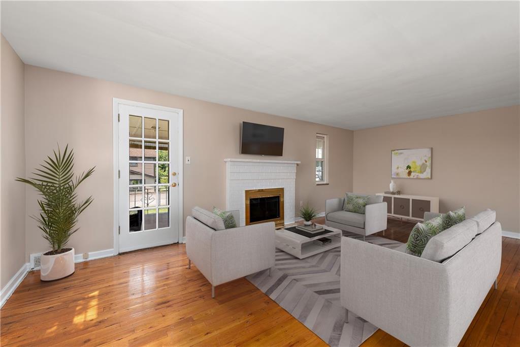 908 Greenhill Road Pittsburgh, PA 15209 - Photo 3 of 23 a living room with furniture a flat screen tv and a fireplace