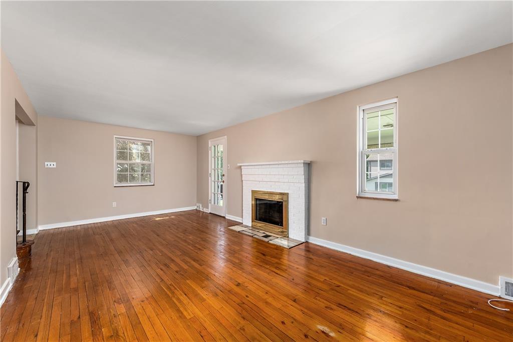 908 Greenhill Road Pittsburgh, PA 15209 - Photo 7 of 23 a view of empty room with wooden floor and fireplace