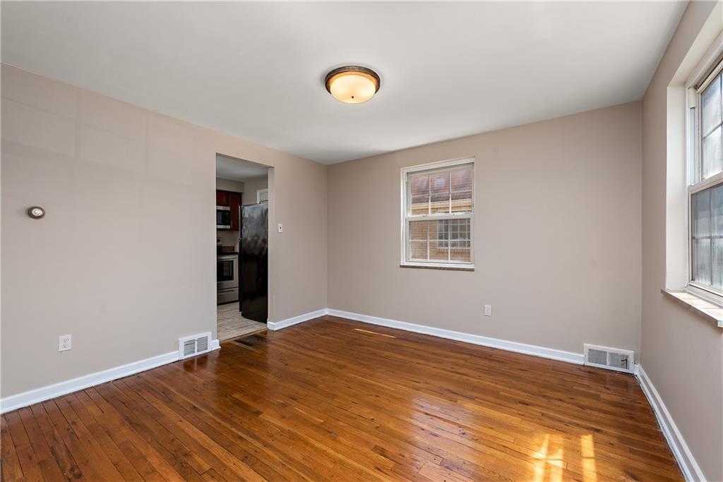 908 Greenhill Road Pittsburgh, PA 15209 - Photo 8 of 23 a view of an empty room with wooden floor and a window