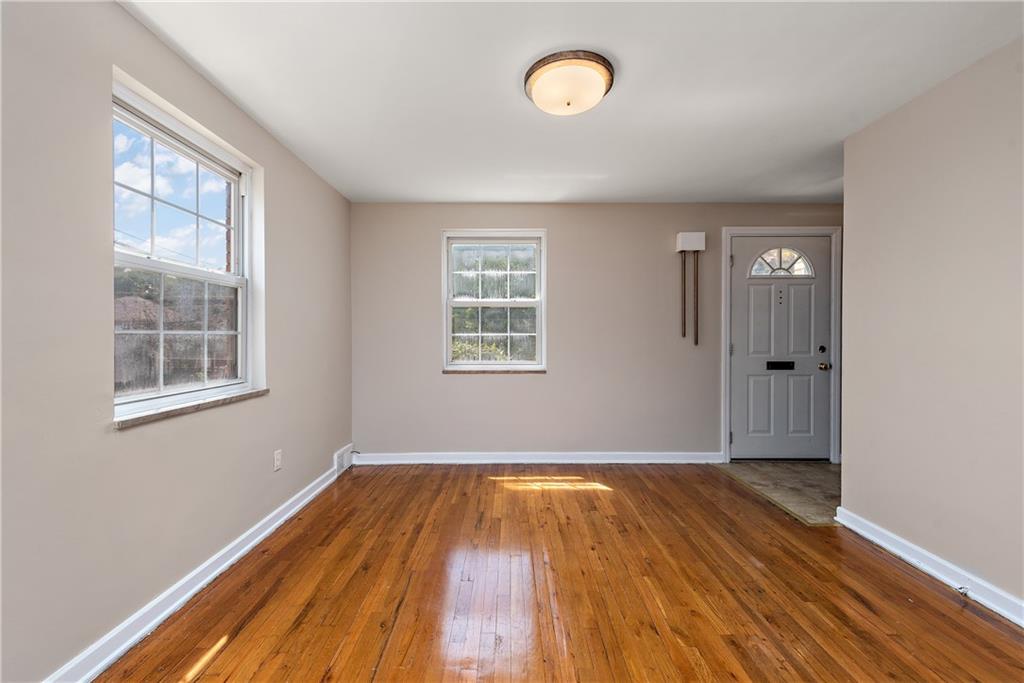 908 Greenhill Road Pittsburgh, PA 15209 - Photo 9 of 23 an empty room with wooden floor and windows