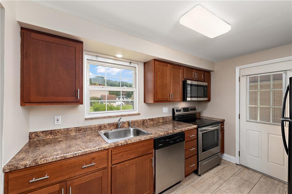 908 Greenhill Road Pittsburgh, PA 15209 - Photo 10 of 23 a kitchen with granite countertop a sink stainless steel appliances and cabinets