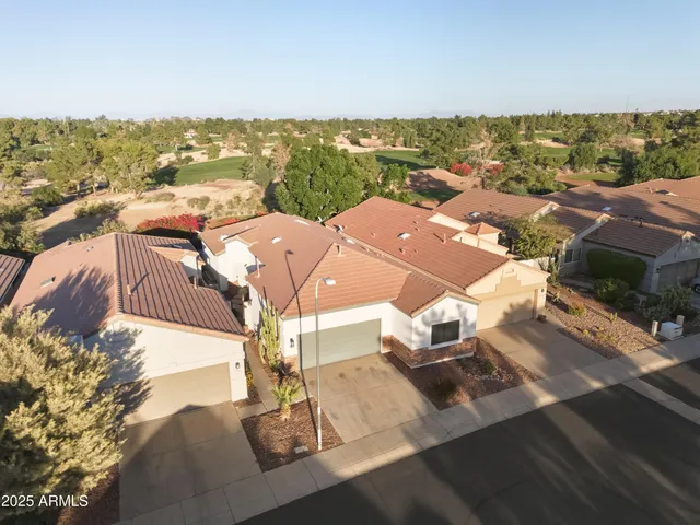an aerial view of residential houses with outdoor space