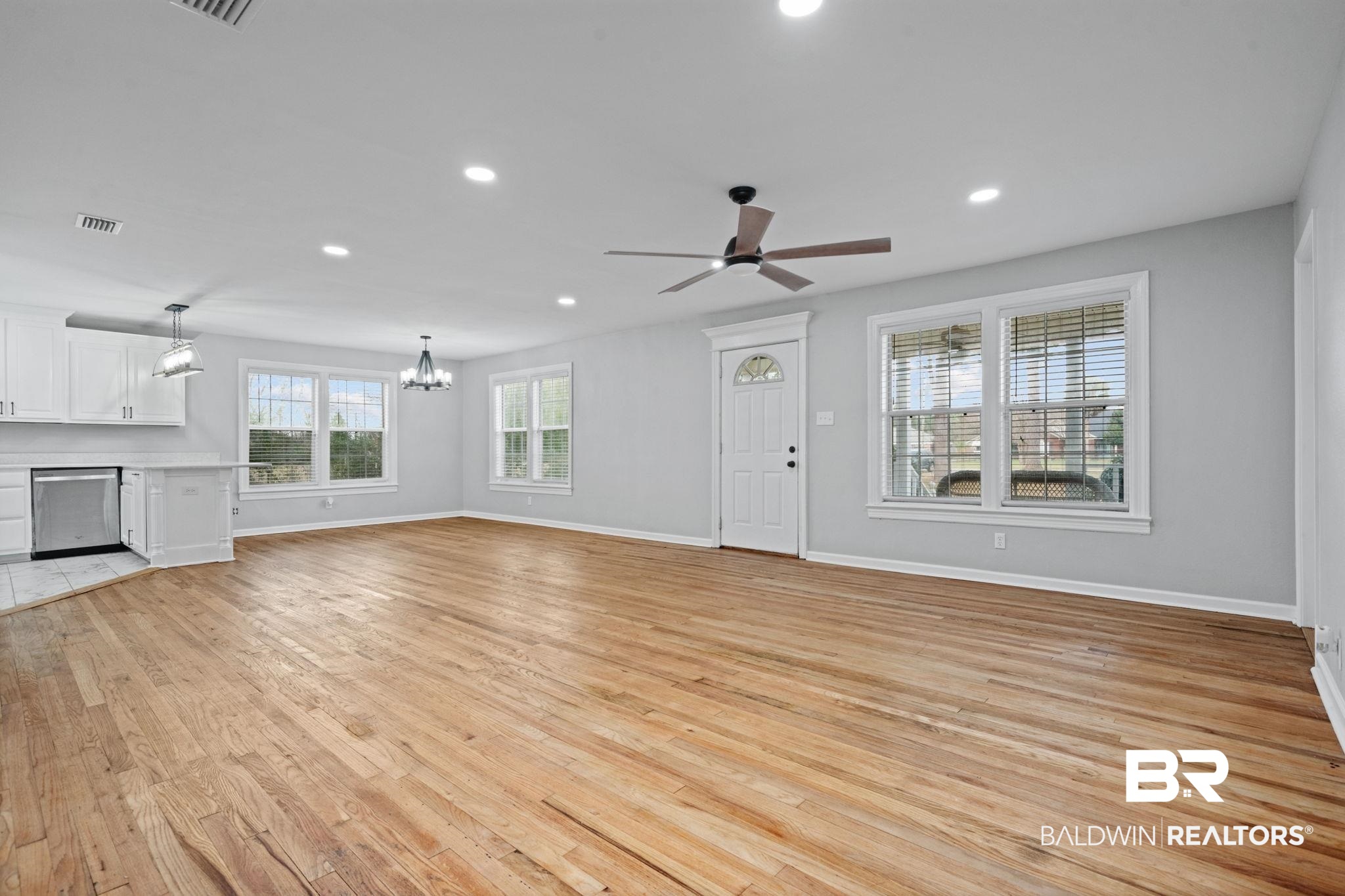 13461 Tom Gaston Road Mobile, AL 36695 - Photo 20 of 41 Unfurnished living room with light wood-type flooring, recessed lighting, ceiling fan, and a chandelier