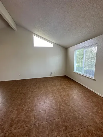 an empty room with a empty space and windows