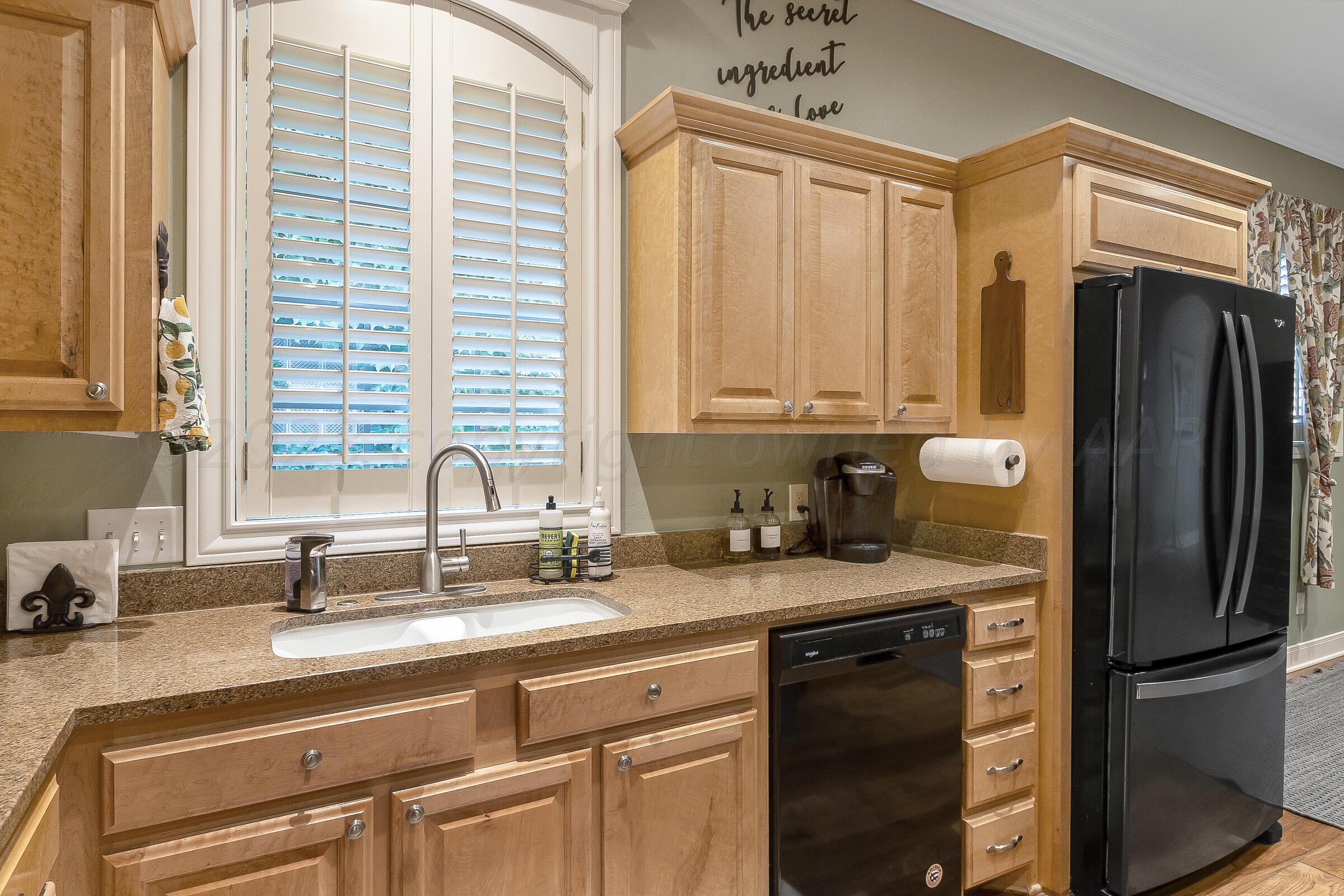 6202 Raintree Court Amarillo, TX 79119 - Photo 11 of 36 a kitchen with appliances a sink and cabinets