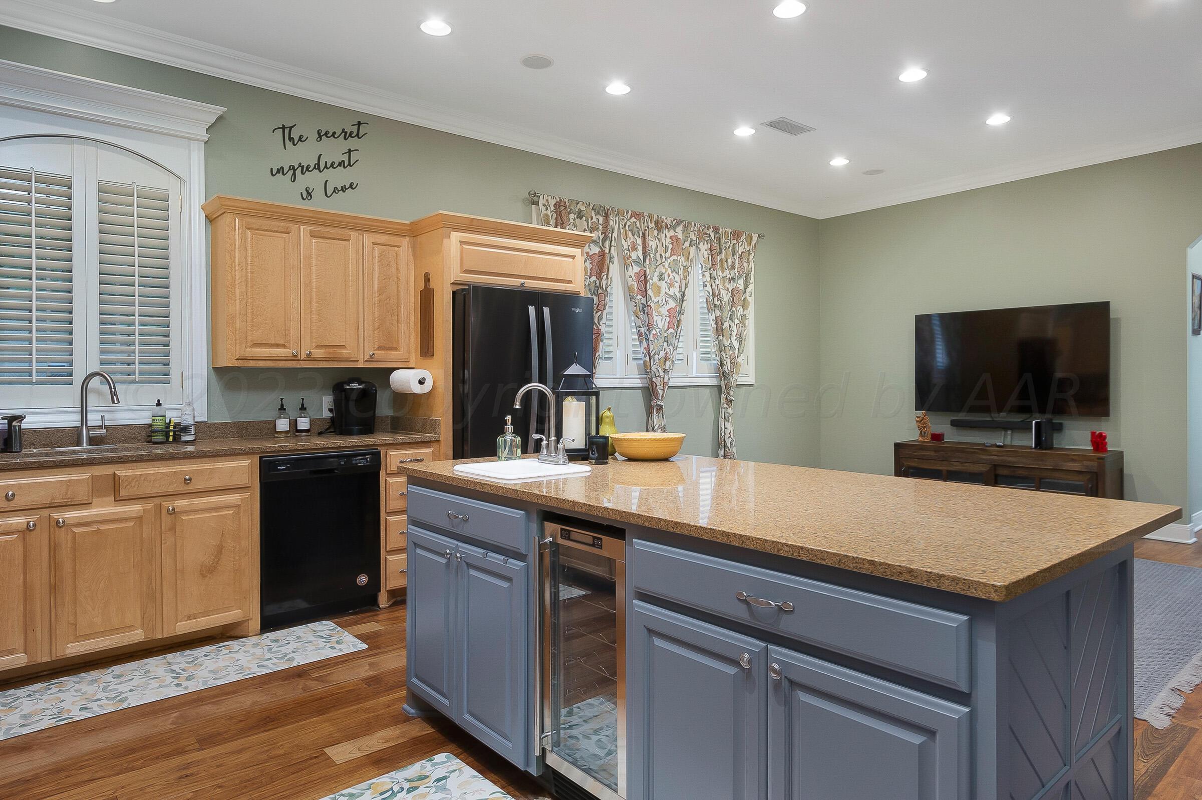 6202 Raintree Court Amarillo, TX 79119 - Photo 12 of 36 a kitchen with a stove a sink and a refrigerator