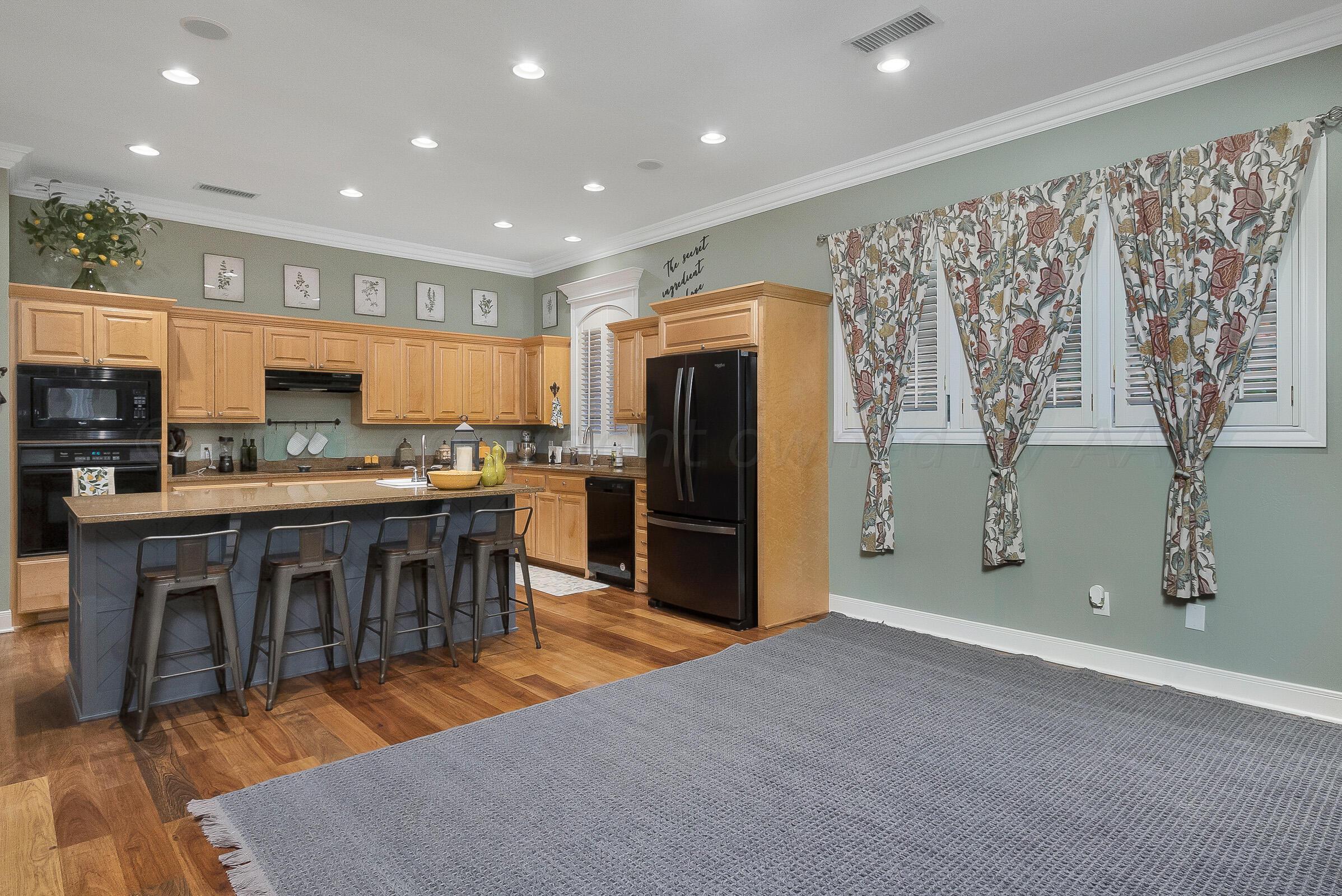 6202 Raintree Court Amarillo, TX 79119 - Photo 13 of 36 a open kitchen with stainless steel appliances granite countertop a refrigerator and a stove top oven