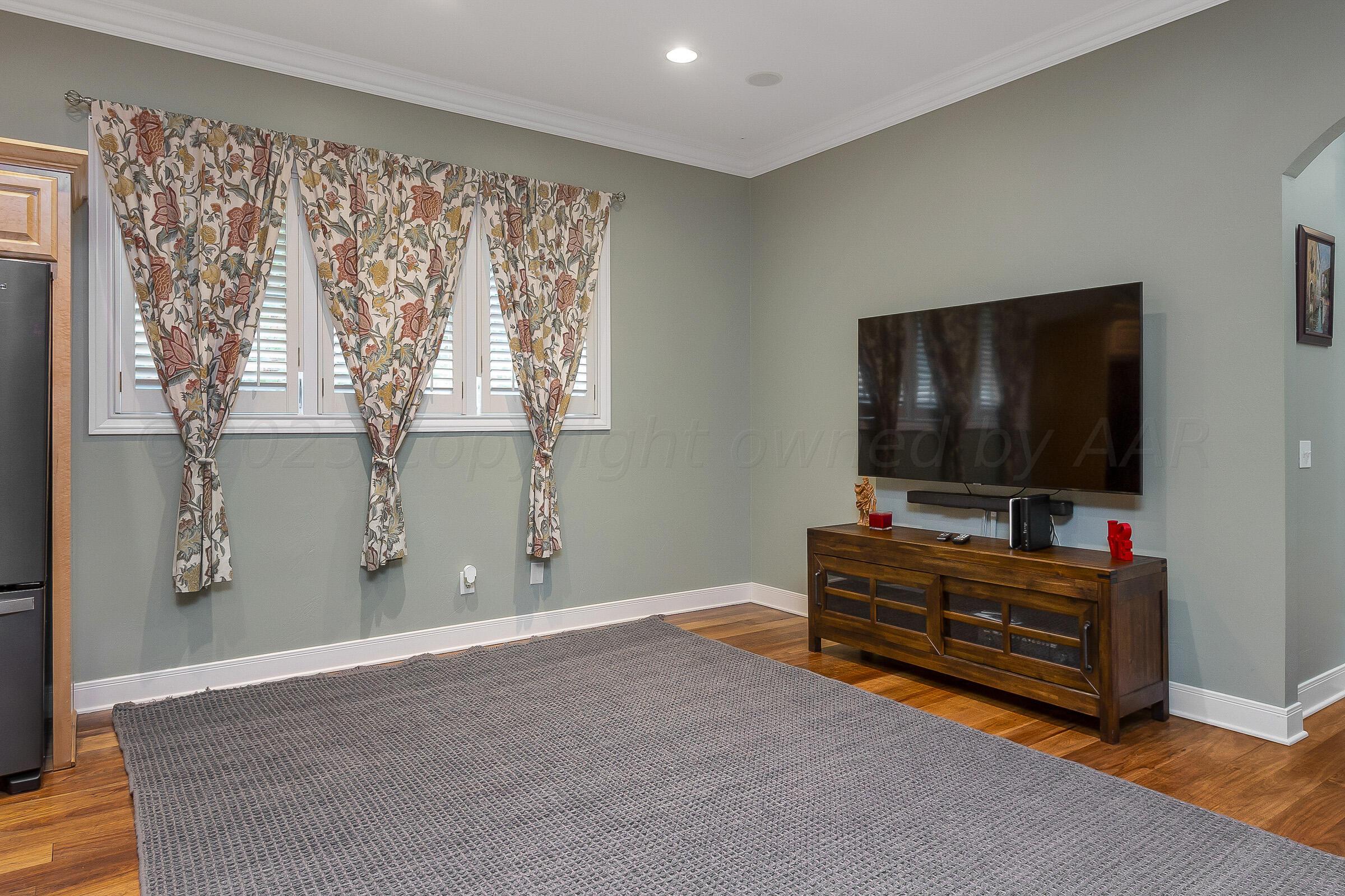 6202 Raintree Court Amarillo, TX 79119 - Photo 14 of 36 a living room with furniture and a flat screen tv
