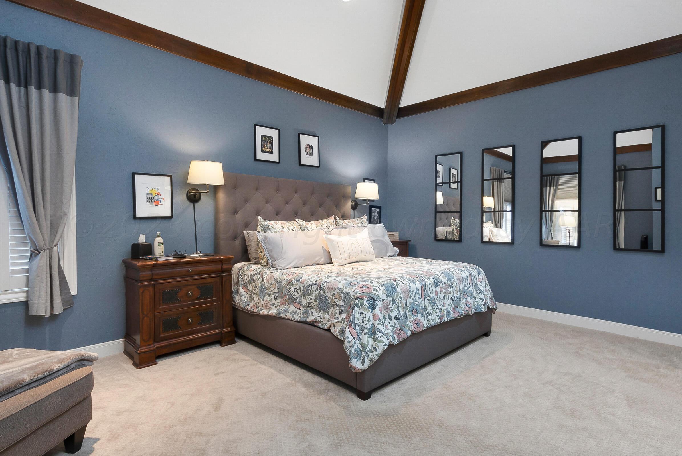 6202 Raintree Court Amarillo, TX 79119 - Photo 16 of 36 a bedroom with a bed and painting on the wall