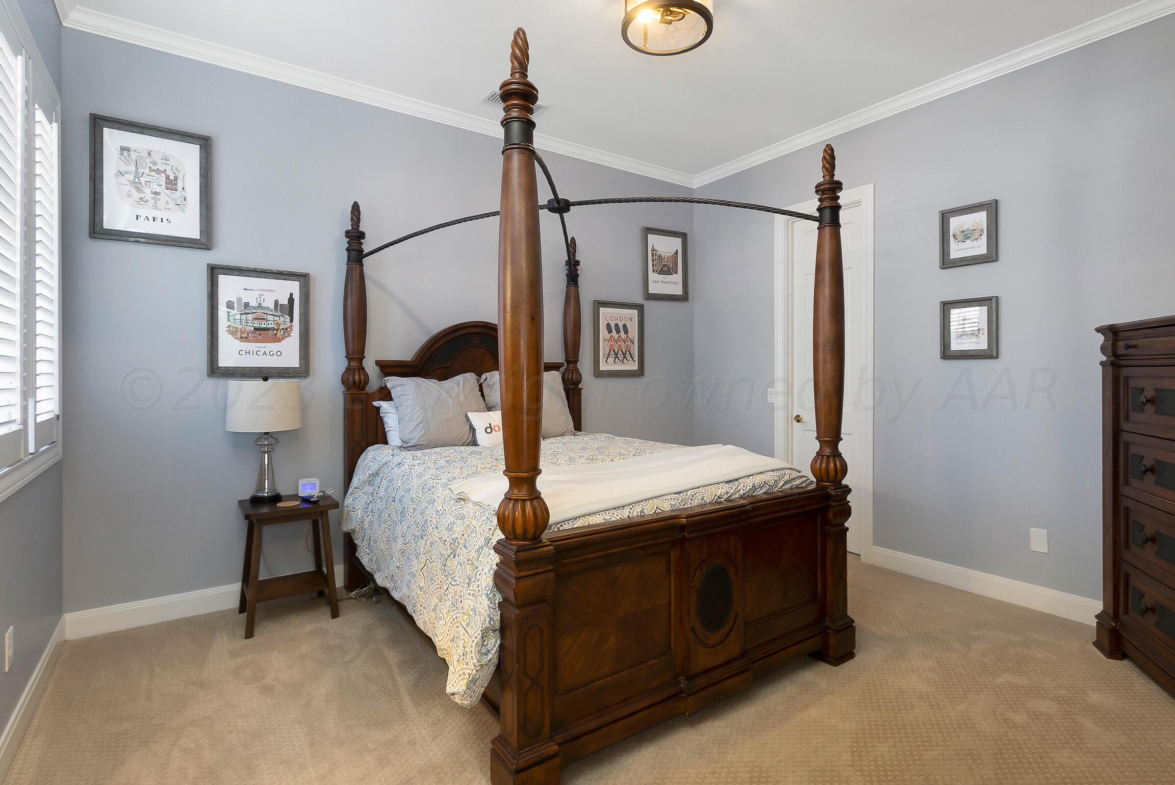 6202 Raintree Court Amarillo, TX 79119 - Photo 22 of 36 a bed sitting in a bedroom next to a window