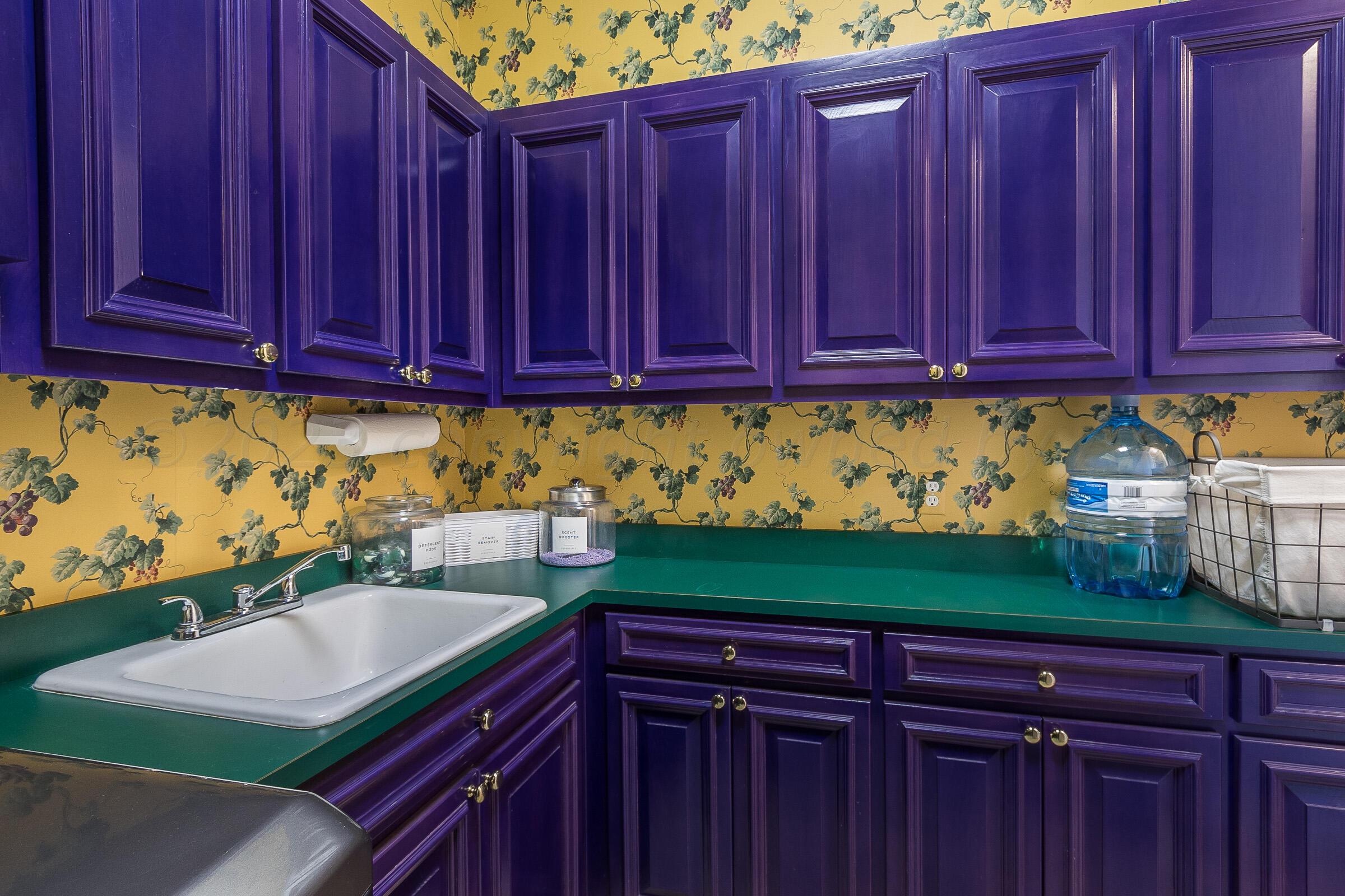 6202 Raintree Court Amarillo, TX 79119 - Photo 27 of 36 a kitchen with wooden cabinets and a sink