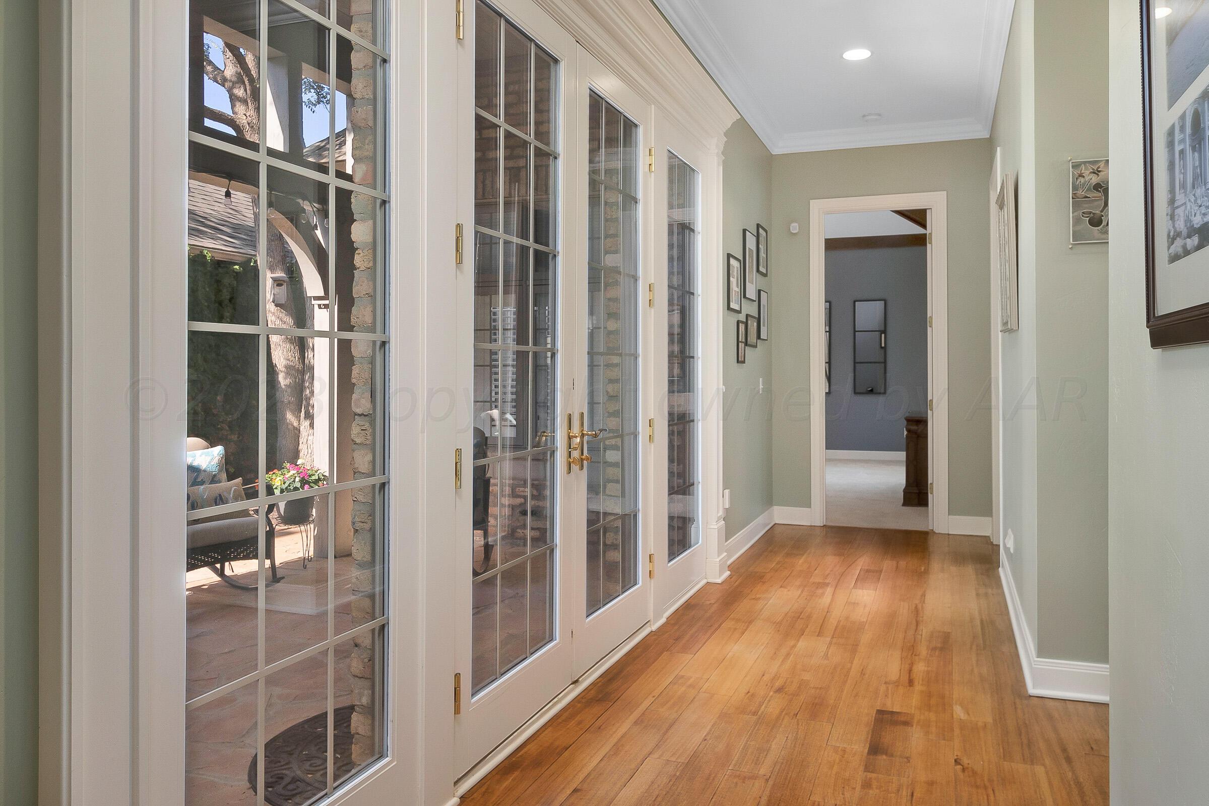 6202 Raintree Court Amarillo, TX 79119 - Photo 28 of 36 a view of a hallway with wooden floor and staircase