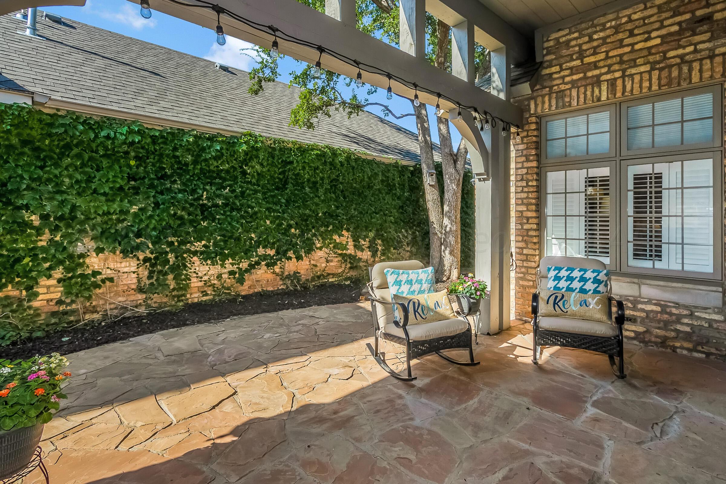6202 Raintree Court Amarillo, TX 79119 - Photo 30 of 36 a view of a patio with a table and chairs and potted plants