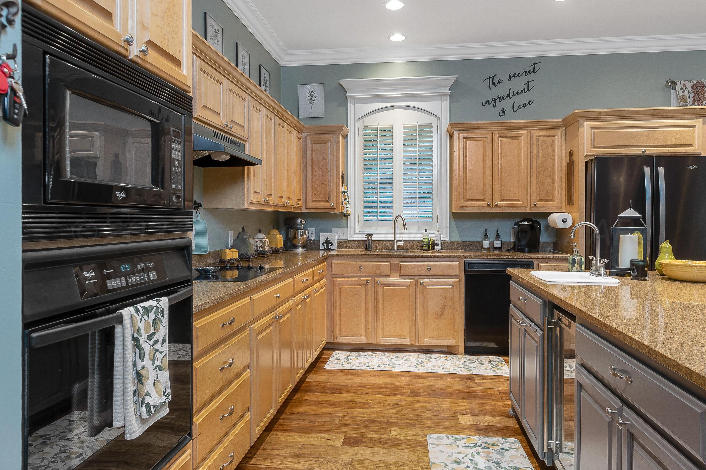6202 Raintree Court Amarillo, TX 79119 - Photo 4 of 36 a kitchen with stainless steel appliances granite countertop a stove a sink and a microwave