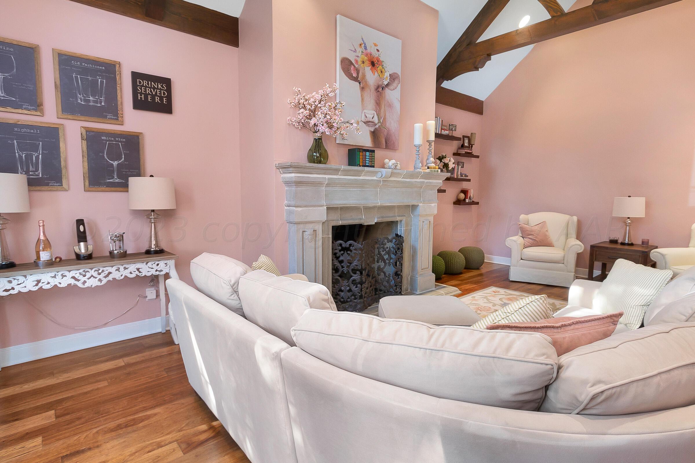 6202 Raintree Court Amarillo, TX 79119 - Photo 6 of 36 a living room with furniture and a fireplace