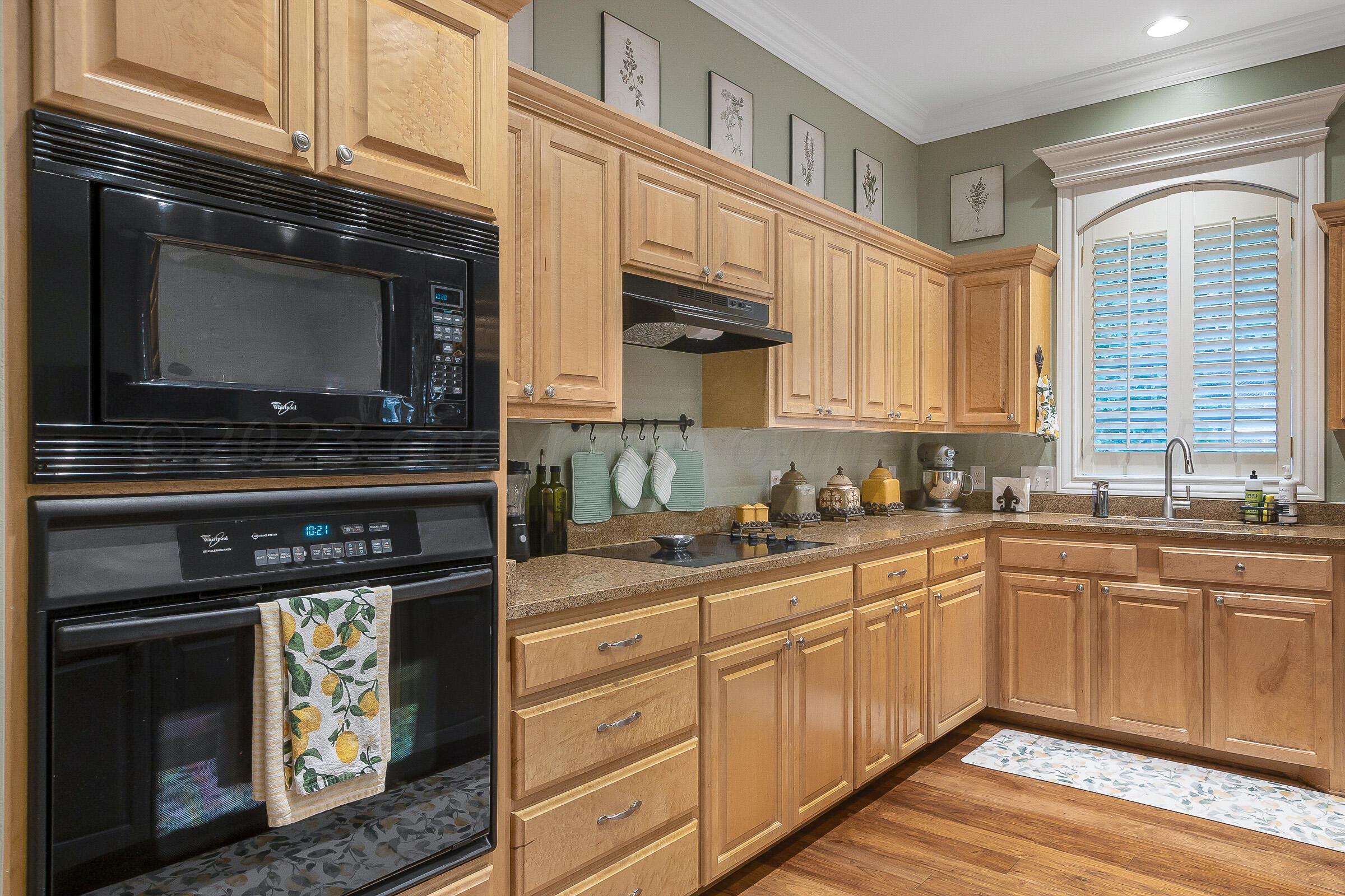 6202 Raintree Court Amarillo, TX 79119 - Photo 10 of 36 a kitchen with stainless steel appliances granite countertop a stove microwave and sink