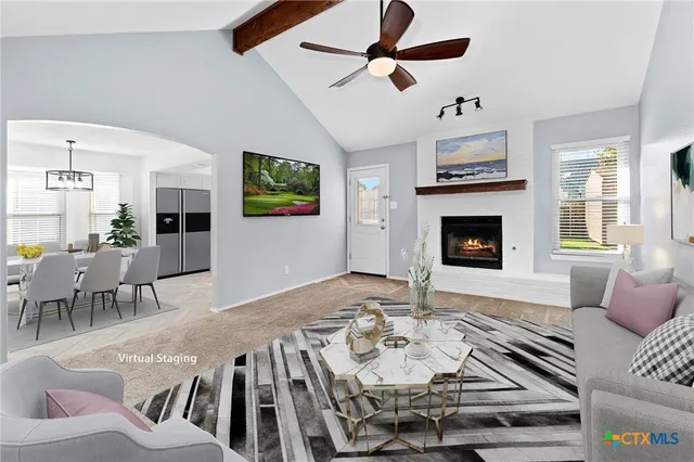 a living room with furniture fireplace and a flat screen tv