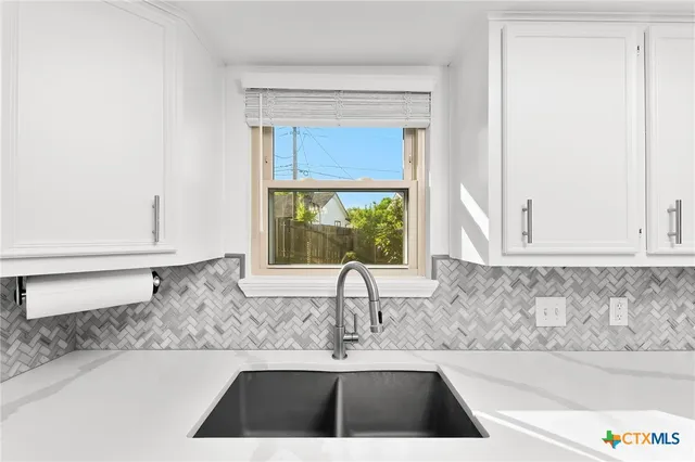 a kitchen with a sink and a window