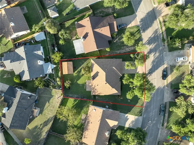 an aerial view of residential houses with outdoor space