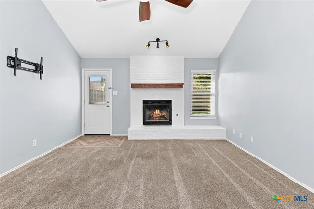a view of an empty room with a fireplace