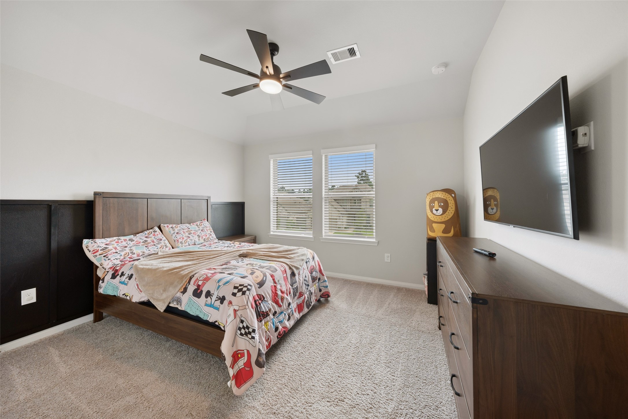 17323 Grand Canyon Road Conroe, TX 77302 - Photo 26 of 33 Bedroom number 4 is off a private hallway on the other side of the game room. Enhanced by a trendy ceiling fan and decorator half wall. The hall bath is adjacent.