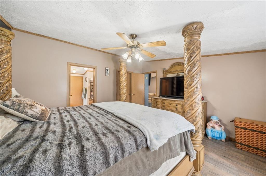 275 Adamik Road Clarksville, PA 15322 - Photo 8 of 39 a bedroom with a bed and a chandelier