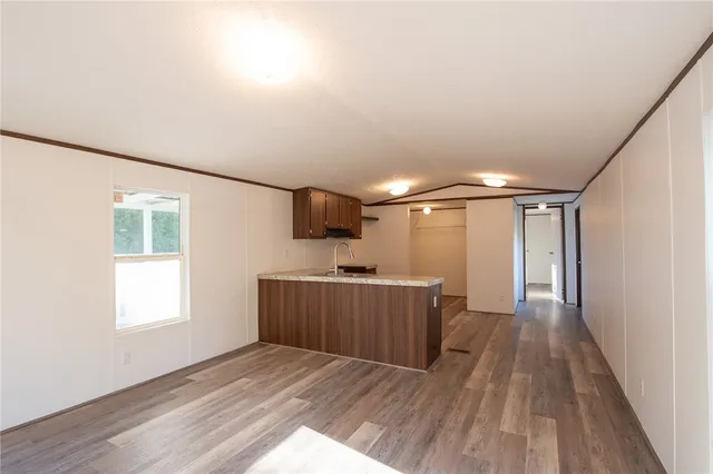a view of a livingroom with a furniture wooden floor and window