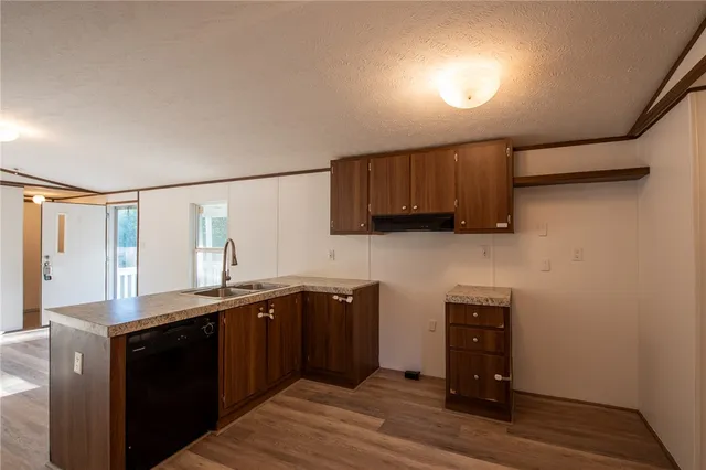 a kitchen with stainless steel appliances granite countertop a sink stove and cabinets