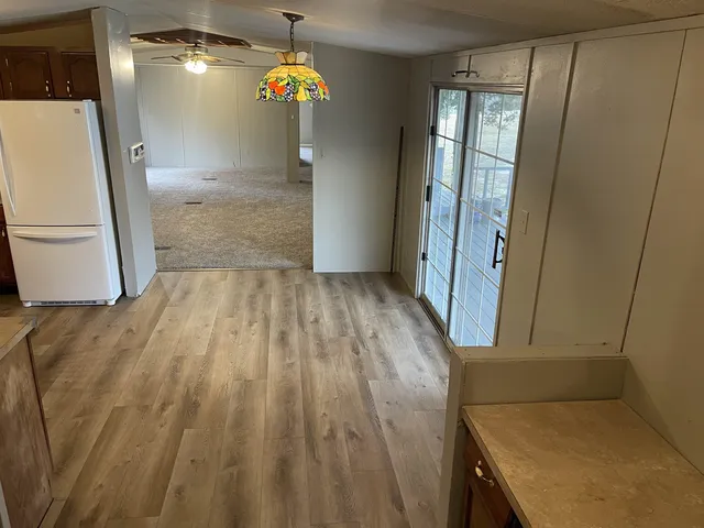 a kitchen with a refrigerator sink and wooden cabinets
