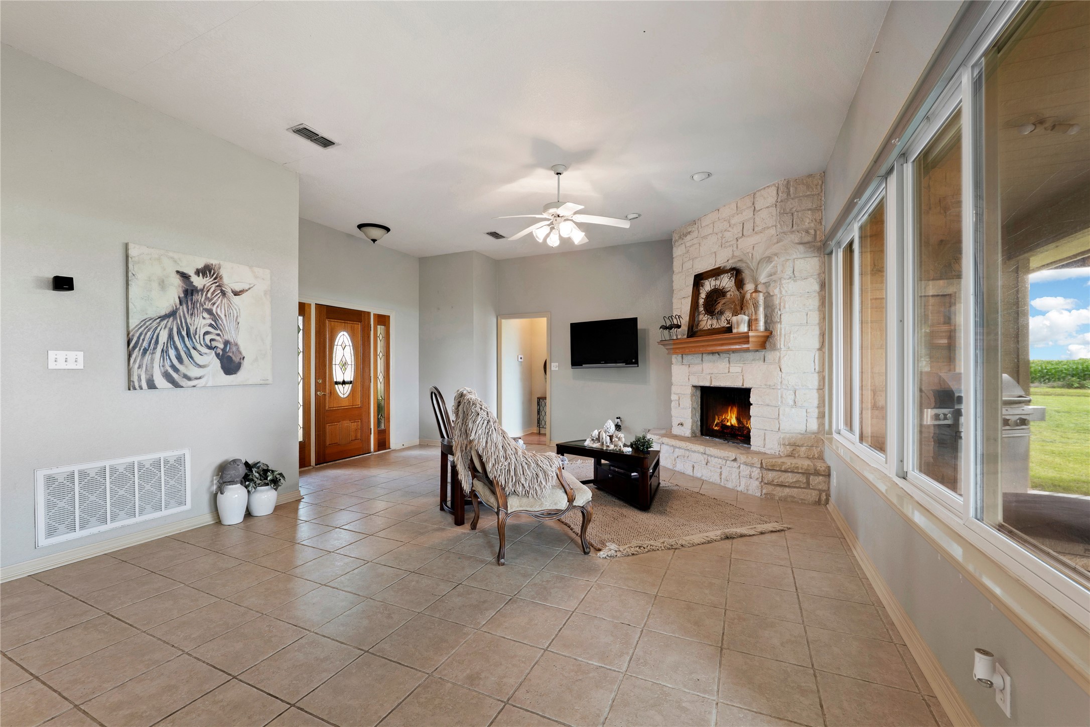1005 East Buttercup Road Taylor, TX 76574 - Photo 22 of 38 a living room with furniture a fireplace and a flat screen tv