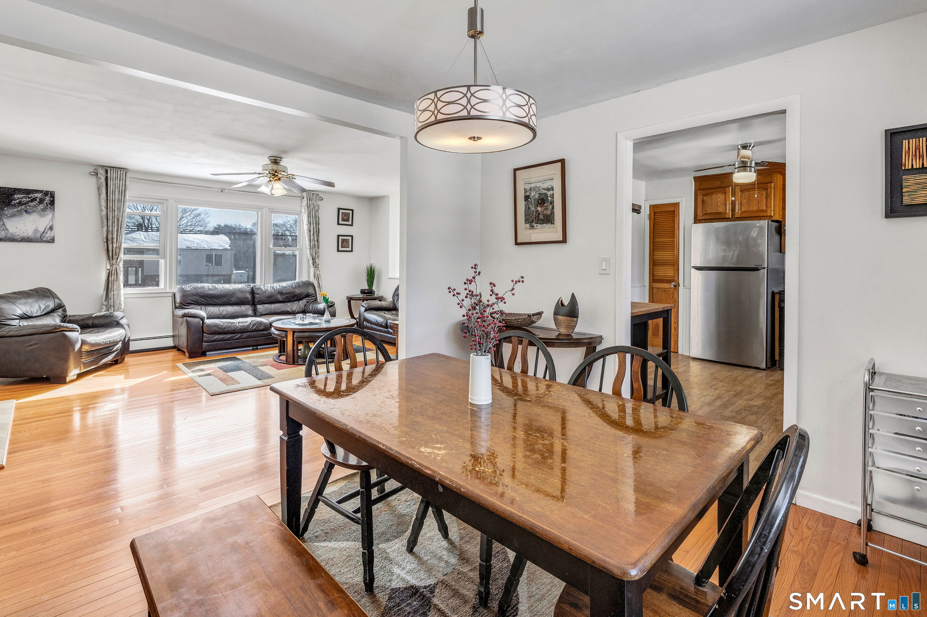 39 Zephyr Road Trumbull, CT 06611 - Photo 19 of 36 a dining room with wooden floor a chandelier a wooden table and chairs