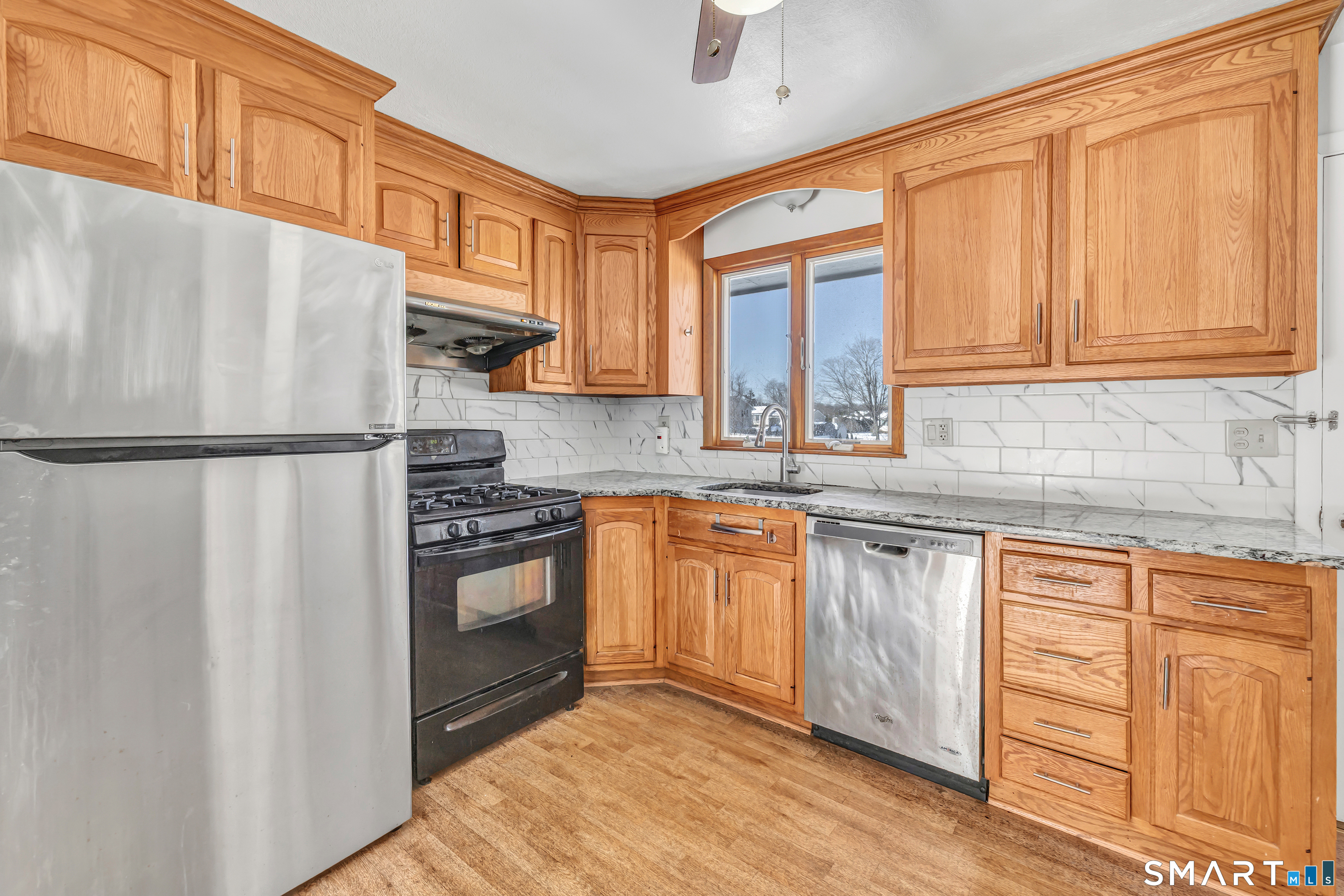 39 Zephyr Road Trumbull, CT 06611 - Photo 21 of 36 a kitchen with granite countertop a refrigerator stove top oven and sink