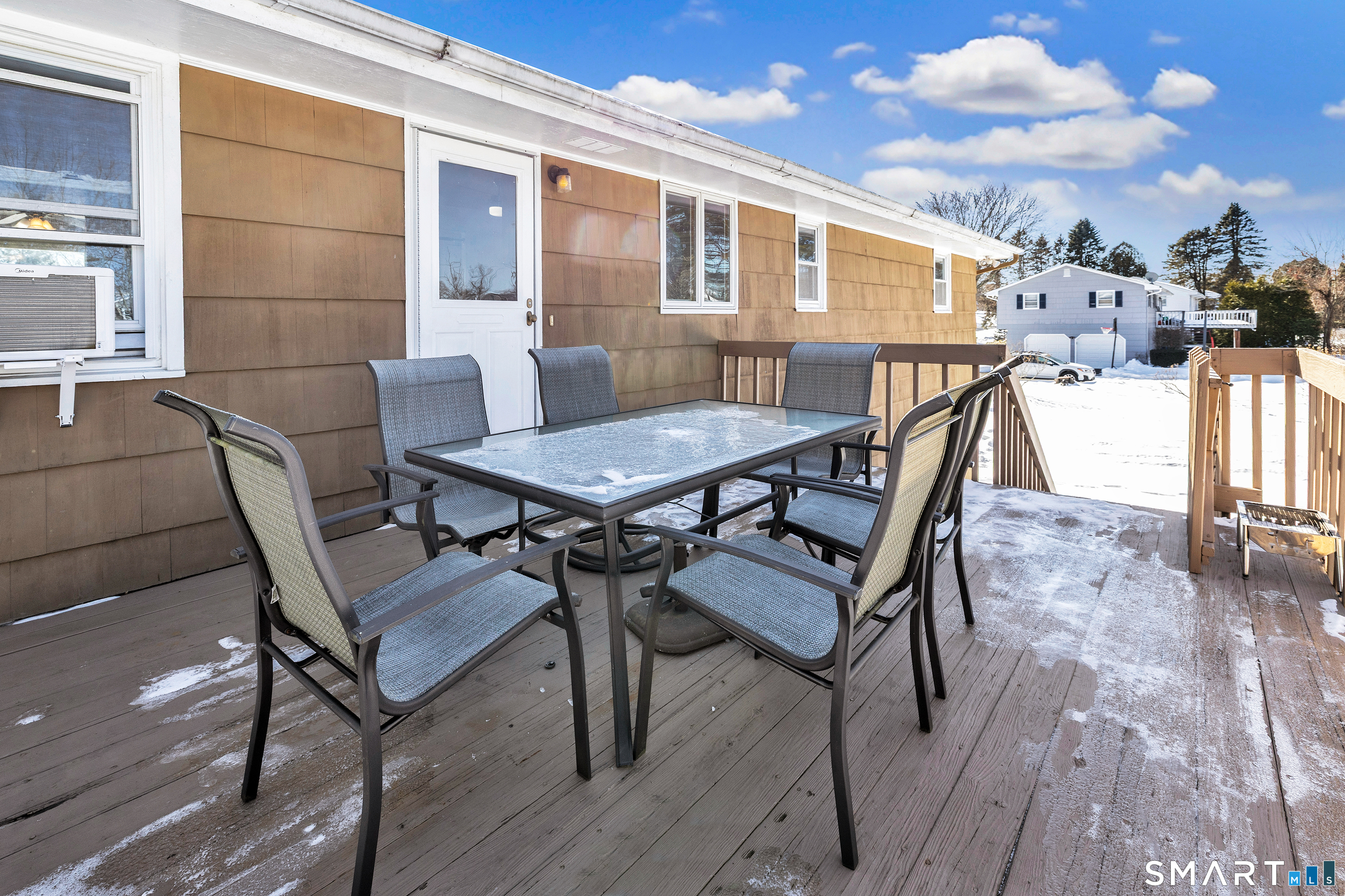 39 Zephyr Road Trumbull, CT 06611 - Photo 3 of 36 a view of a patio with table and chairs with wooden floor