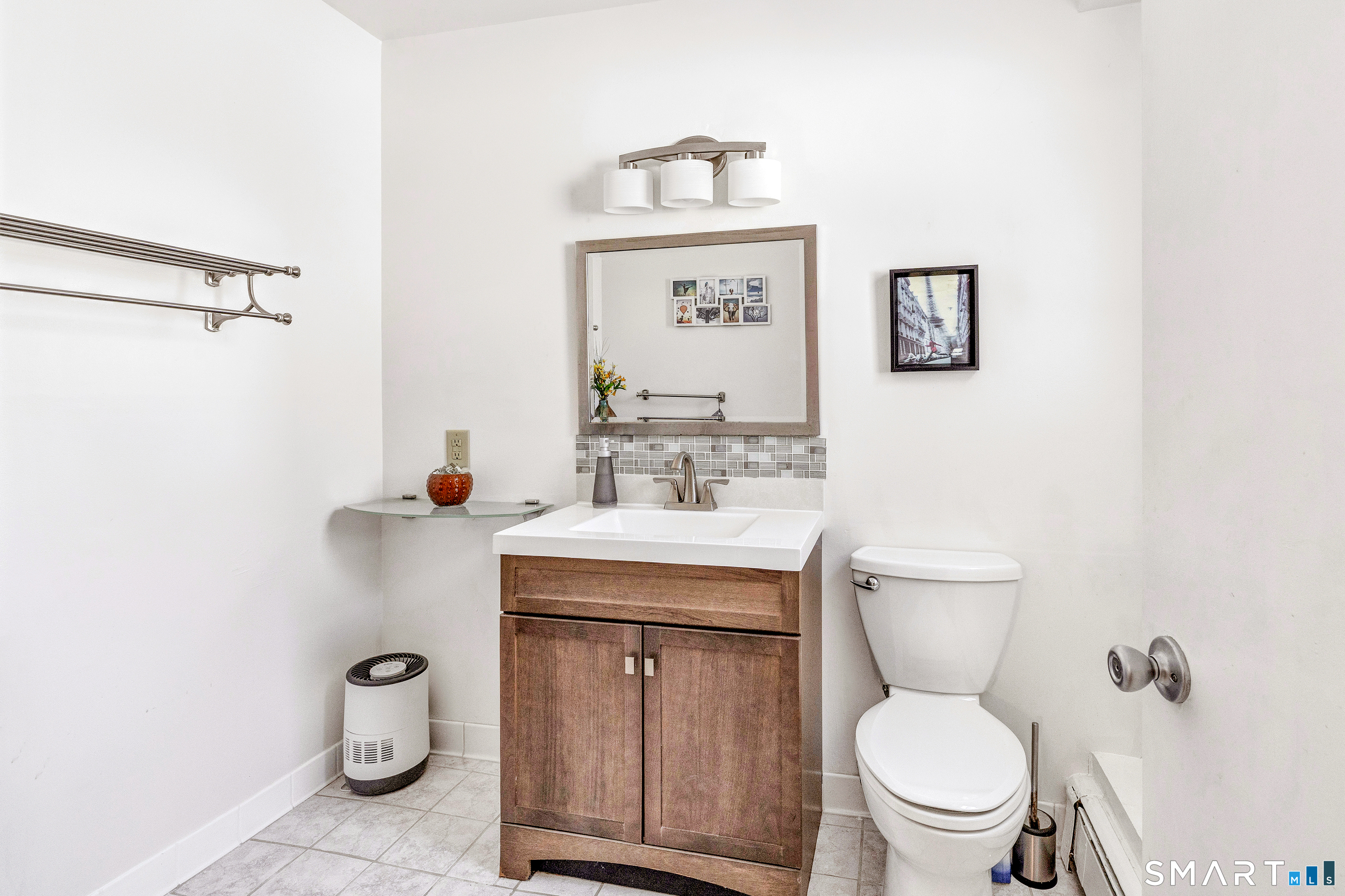 39 Zephyr Road Trumbull, CT 06611 - Photo 35 of 36 a bathroom with a toilet sink vanity and mirror