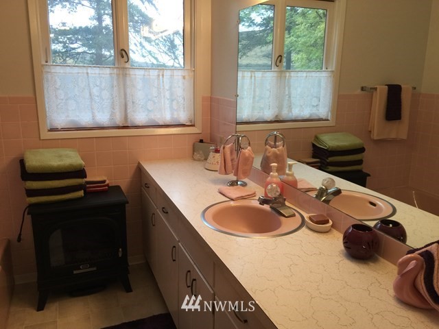 245 Messner Road Dayton, WA 99328 - Photo 17 of 30 a bathroom with a double vanity sink and a mirror