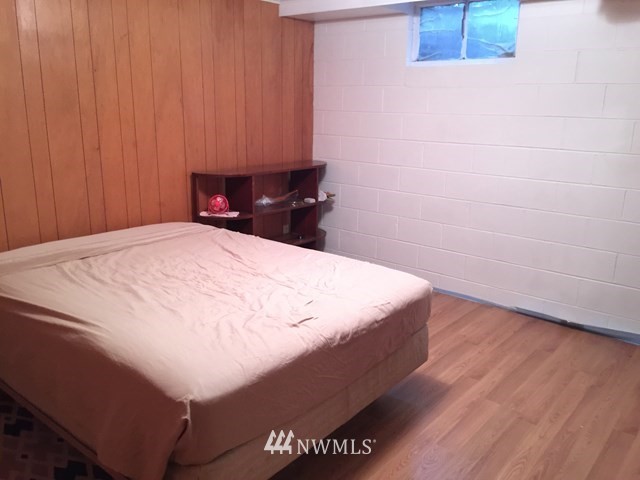 245 Messner Road Dayton, WA 99328 - Photo 19 of 30 a bed sitting in a bedroom and wooden floor