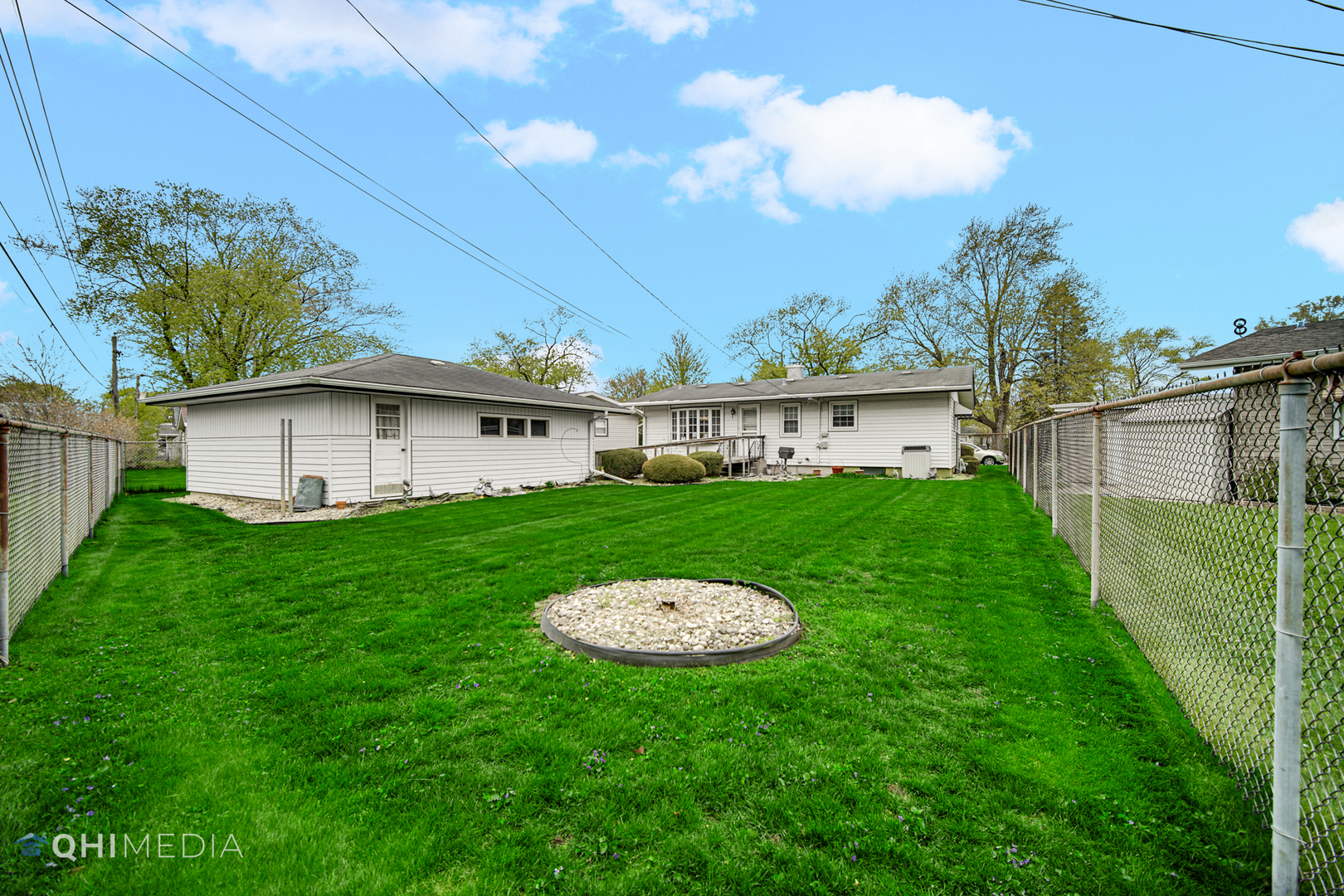 74 Arrowhead Drive Thornton, IL 60476 - Photo 24 of 26 a view of a white house with a big yard plants and large trees